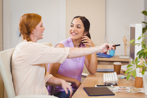 Businesswoman showing something on computer to happy colleague  Stock photo © wavebreak_media