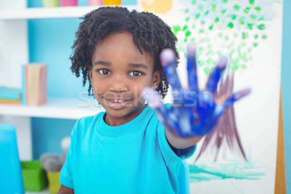 Happy kid enjoying painting with his hands Stock photo © wavebreak_media