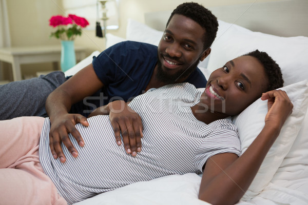 Man touching woman stomach in bedroom Stock photo © wavebreak_media