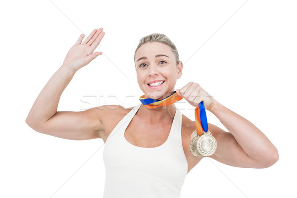 Boldog női atléta tart medálok fehér Stock fotó © wavebreak_media
