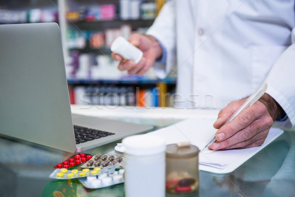 Pharmacist writing prescriptions for medicines Stock photo © wavebreak_media