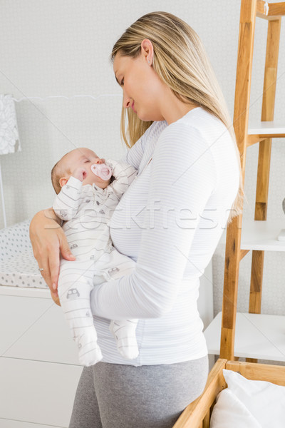 Mother holding her baby boy Stock photo © wavebreak_media