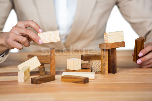 Businesswoman placing wooden block on a tower Stock photo © wavebreak_media