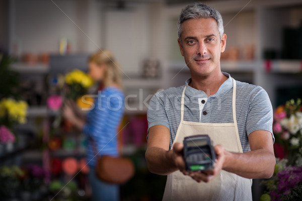 Florist showing credit card terminal in flower shop Stock photo © wavebreak_media