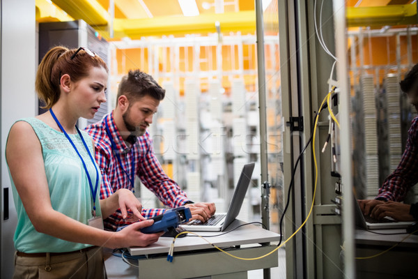 Technicians using laptop while analyzing server Stock photo © wavebreak_media