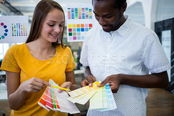 Graphic designer discussing over color swatch with a colleague Stock photo © wavebreak_media