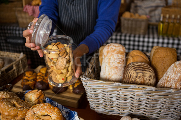 Mid section of staff holding glass jar of cookies at counter Stock photo © wavebreak_media