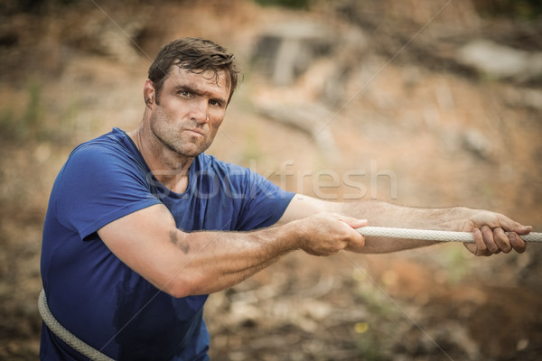 Man playing tug of war during obstacle course Stock photo © wavebreak_media