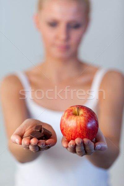 Portrait of awoman holding chocolate and apple focus on apple  Stock photo © wavebreak_media