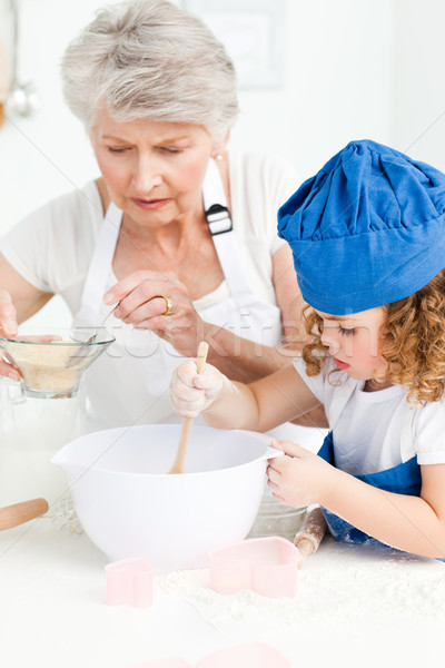 A little girl  baking with her grandmother at home Stock photo © wavebreak_media