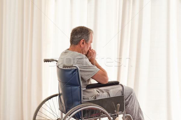 Thoughtful man in his wheelchair at home
 Stock photo © wavebreak_media