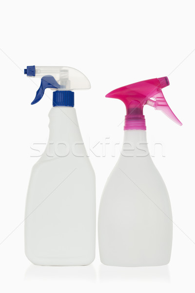 Pink and blue spray bottles against a white background Stock photo © wavebreak_media