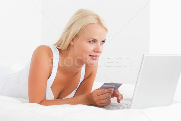 Woman shopping online in her bedroom Stock photo © wavebreak_media
