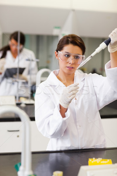 Portrait of a focused student pouring a liquid in a tube in a laboratory Stock photo © wavebreak_media
