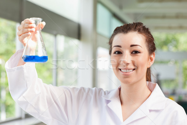 Cute science student holding an Erlemeyer flask in a laboratory Stock photo © wavebreak_media