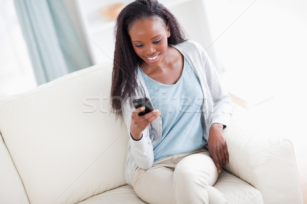 Mosolygó nő kanapé olvas szöveges üzenet ház telefon Stock fotó © wavebreak_media