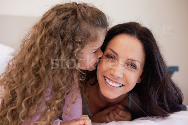 Little daughter giving her young mother a kiss Stock photo © wavebreak_media