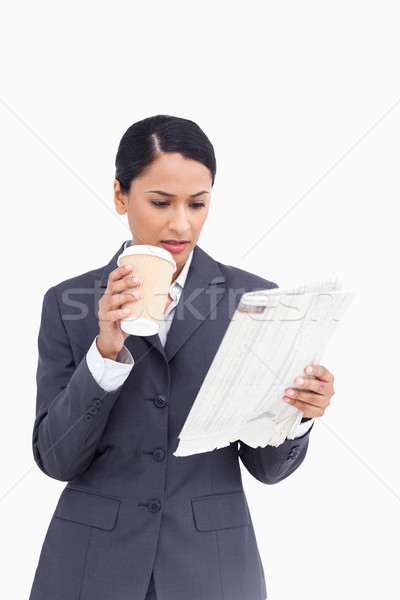 Close up of saleswoman with paper cup and news paper against a white background Stock photo © wavebreak_media