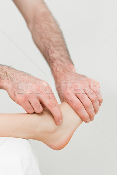 Physiotherapist touching the foot of a patient in a room Stock photo © wavebreak_media