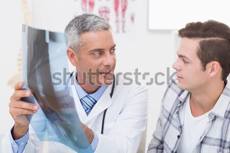 Doctor and a patient talking in an examination room Stock photo © wavebreak_media