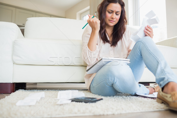 Young woman getting stressed over bills on floor of living room Stock photo © wavebreak_media