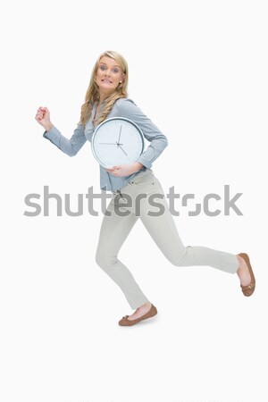 Hurried woman running while holding a big clock Stock photo © wavebreak_media