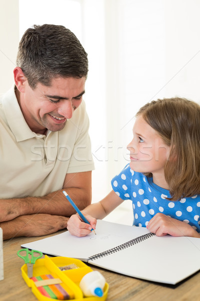 Father looking at daughter drawing Stock photo © wavebreak_media