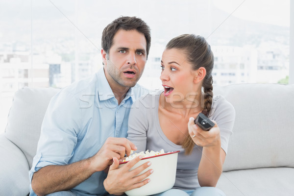 Couple regarder effrayant film canapé bol [[stock_photo]] © wavebreak_media