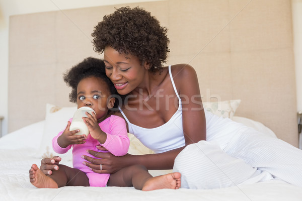 Happy parents with baby girl on their bed Stock photo © wavebreak_media