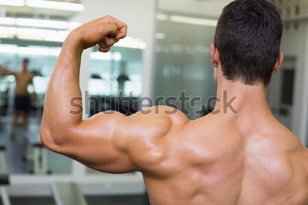Sporty man holding protein drink in gym Stock photo © wavebreak_media