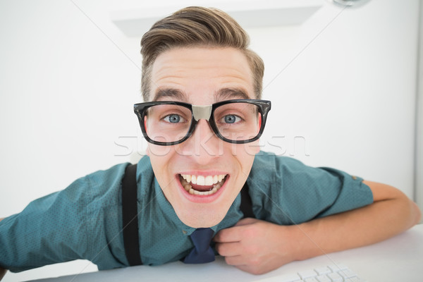 Stock photo: Nerdy businessman at his desk 