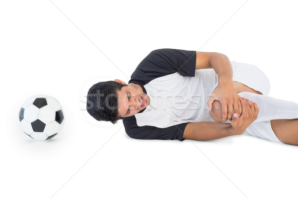 Footballeur couché douleur vue de côté blanche Photo stock © wavebreak_media