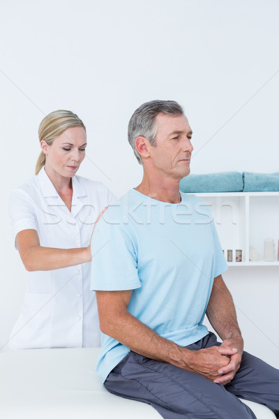 Doctor examining her patient back  Stock photo © wavebreak_media
