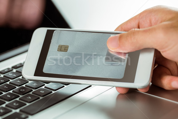 Man using laptop and phone for online shopping Stock photo © wavebreak_media