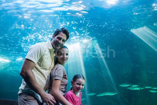 Stock photo: Happy family looking at tank
