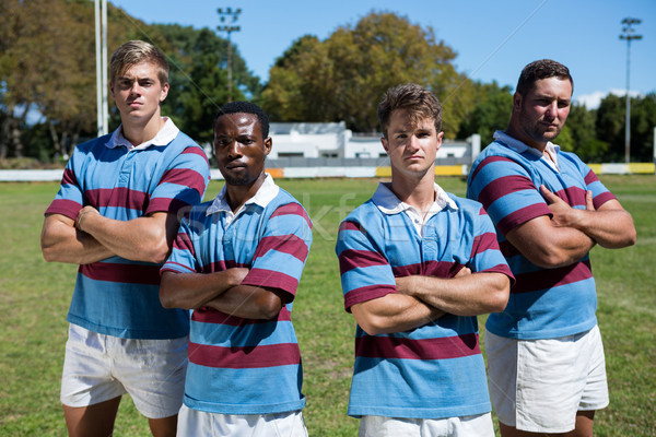 Portrait of confident rugby team standing on grassy field Stock photo © wavebreak_media