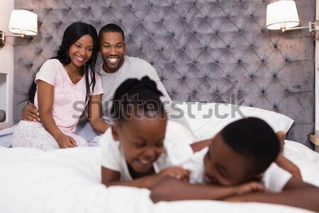 Smiling father and daughter using digital tablet on bed Stock photo © wavebreak_media