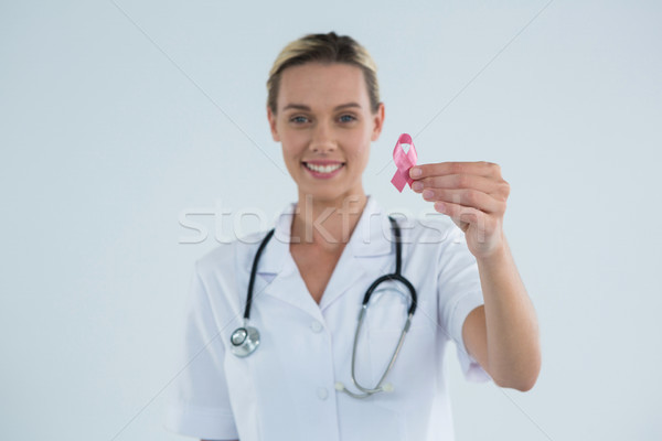 Portrait of female doctor showing Breast Cancer Awareness ribbon Stock photo © wavebreak_media