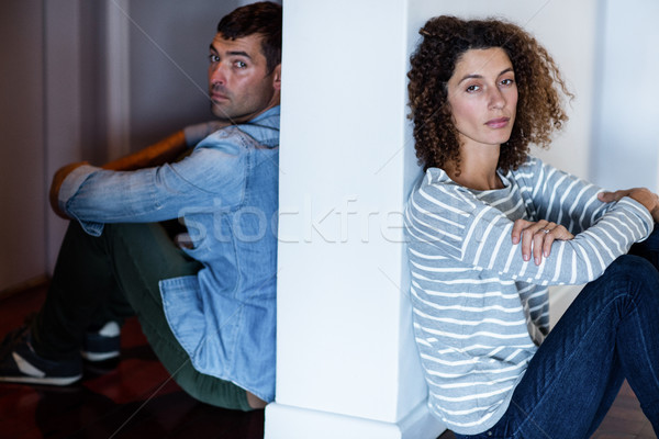 Portrait of couple sitting on opposite sides of the wall Stock photo © wavebreak_media