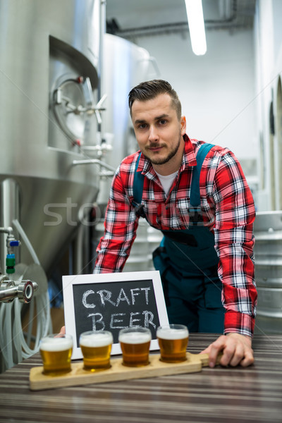 Portrait of brewer with four glasses of craft beer on table Stock photo © wavebreak_media