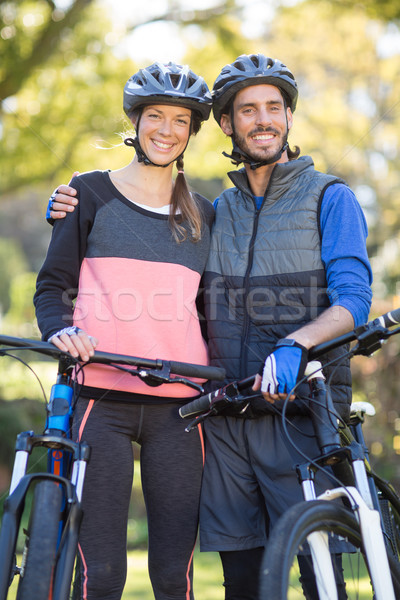 Biker couple with mountain bike in countryside Stock photo © wavebreak_media