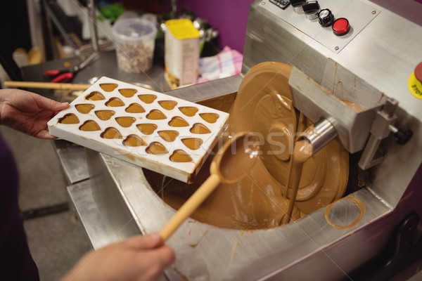 Worker filling mould with melted chocolate Stock photo © wavebreak_media