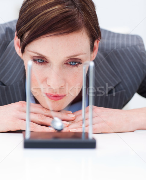 Young businesswoman looking at kinetic balls Stock photo © wavebreak_media