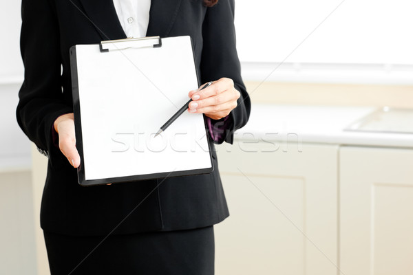 Close-up of a businesswoman holding a clipboard and a pen at home Stock photo © wavebreak_media