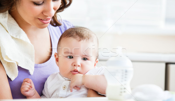 Portrait of a charming mother taking care of her adorable baby in the kitchen at home Stock photo © wavebreak_media