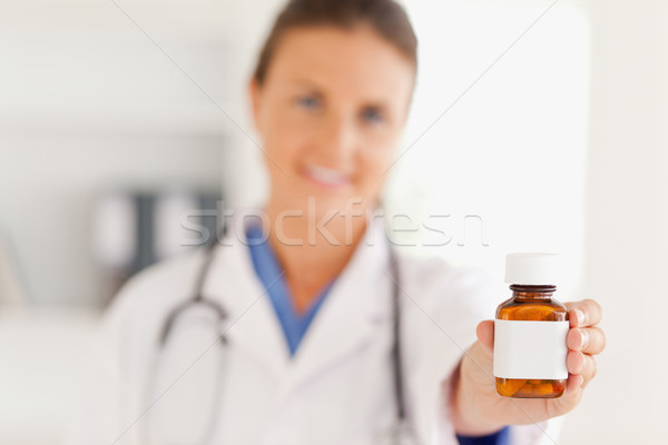 Cute doctor handing over some pills in the surgery Stock photo © wavebreak_media