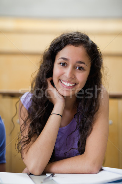 Stock photo: Portrait of smiling student leaning on her hand in an amphitheater