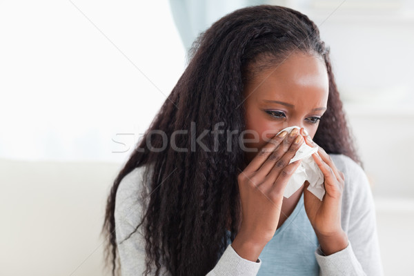Close up of young woman blowing her nose Stock photo © wavebreak_media