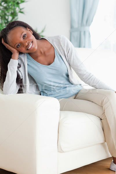 Smiling woman enjoys sitting on the sofa Stock photo © wavebreak_media