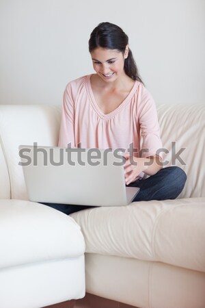 Stock photo: Portrait of a woman using a notebook in her living room